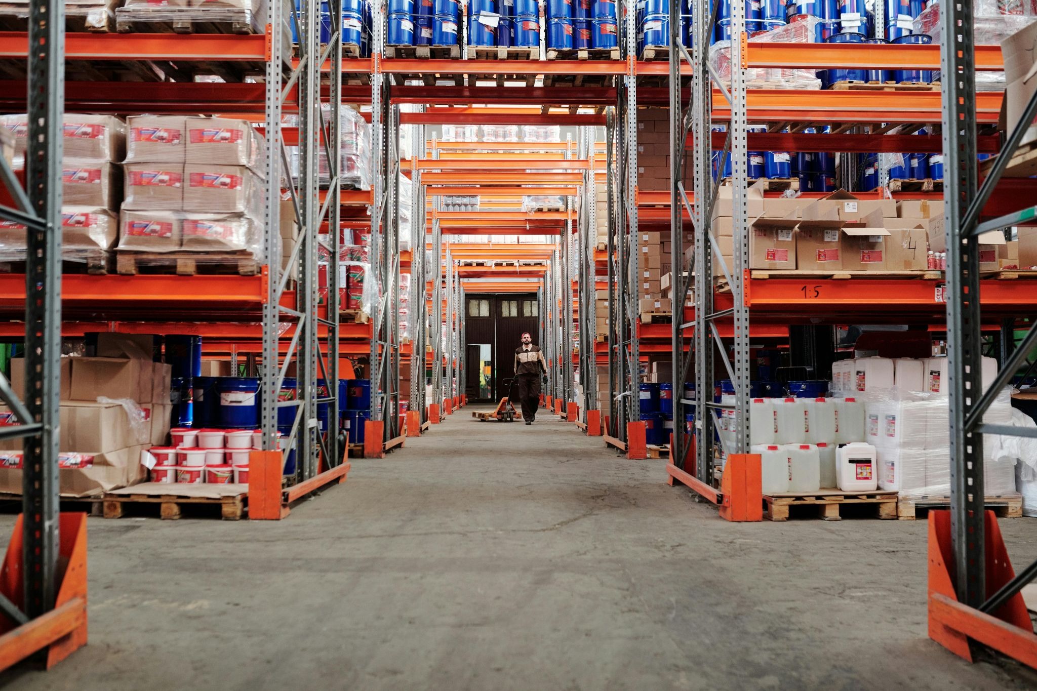Building materials warehouse with organized shelves of cement, construction chemicals, and supplies in the UAE.