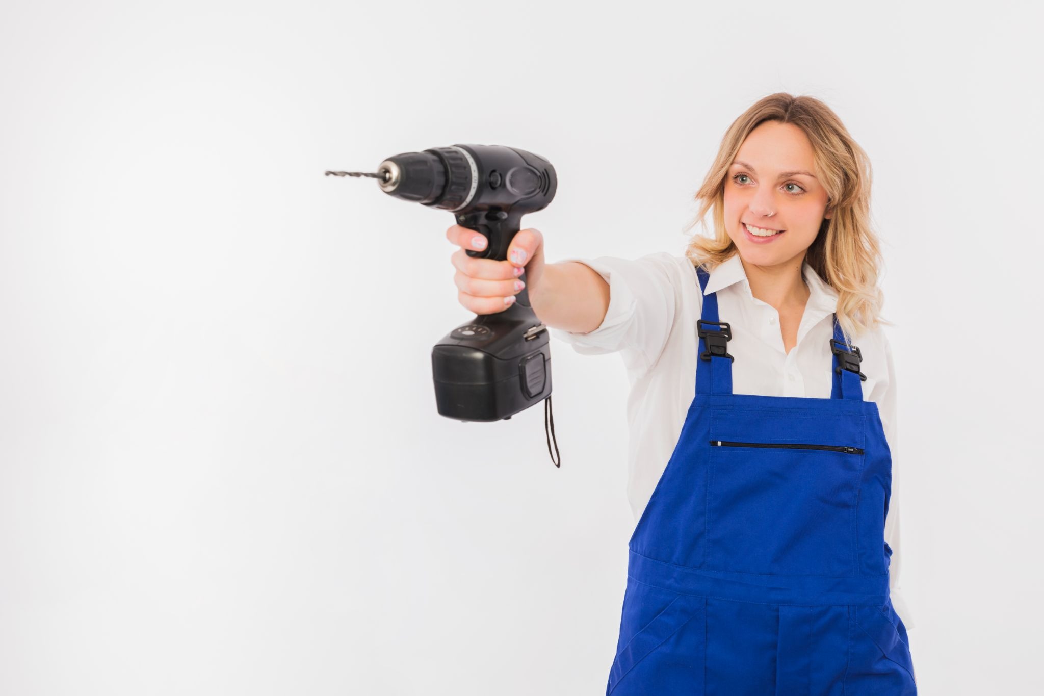 Worker holding power drill machine for construction work